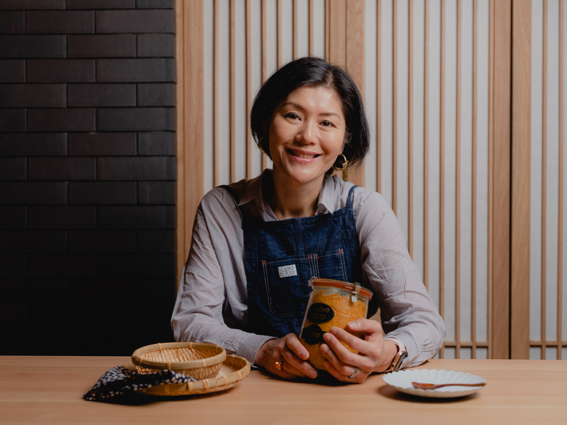 Img:Woman holding jar of miso