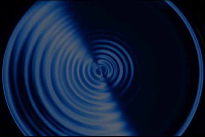 Img:Spiralling design lighter blue on one side, darker blue the other