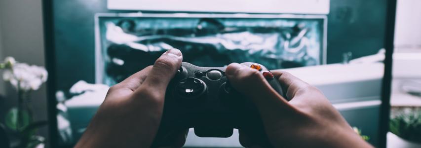 hands holding game console