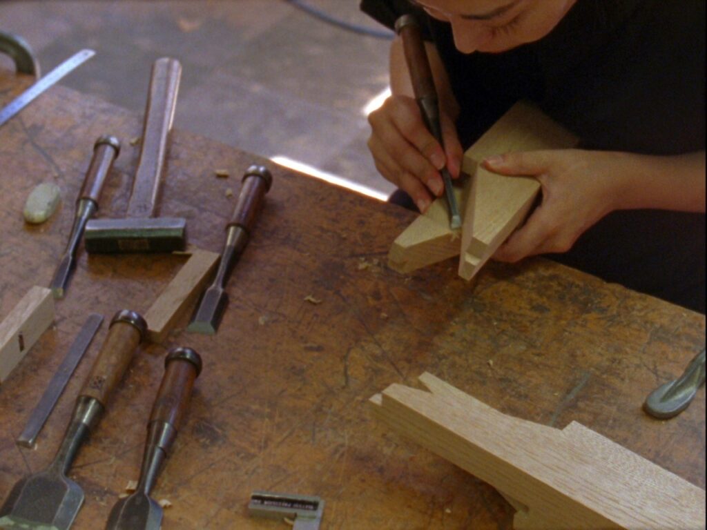 Img:Woman carving woods in her workshop