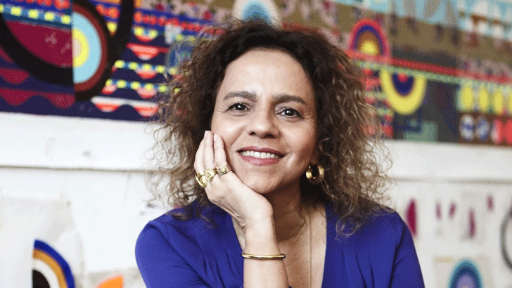 photo:Woman smiling in front of artworks