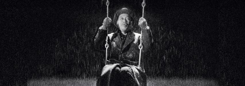 man on swing in the rain