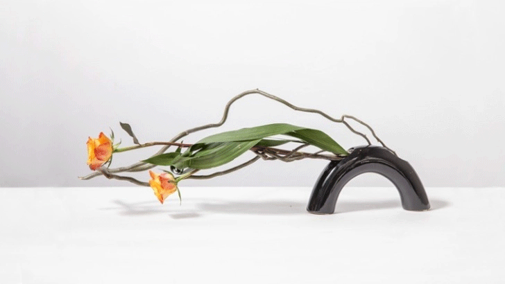 IMG:half ring vase with two yellow tulip and wood on holizontal