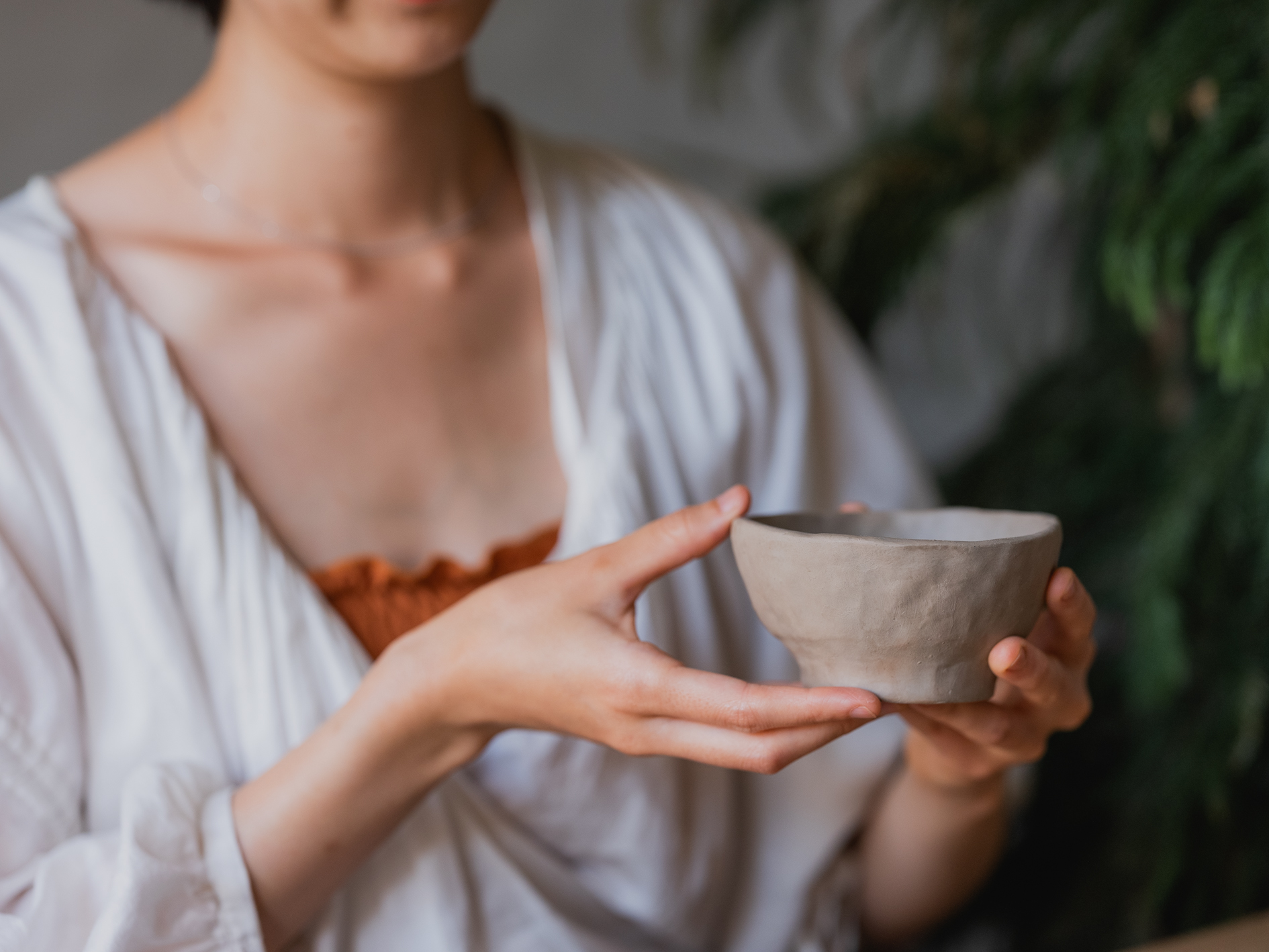 Img:Woman holding ceramic cup