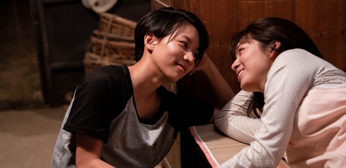 Img: Two women smiling at one another