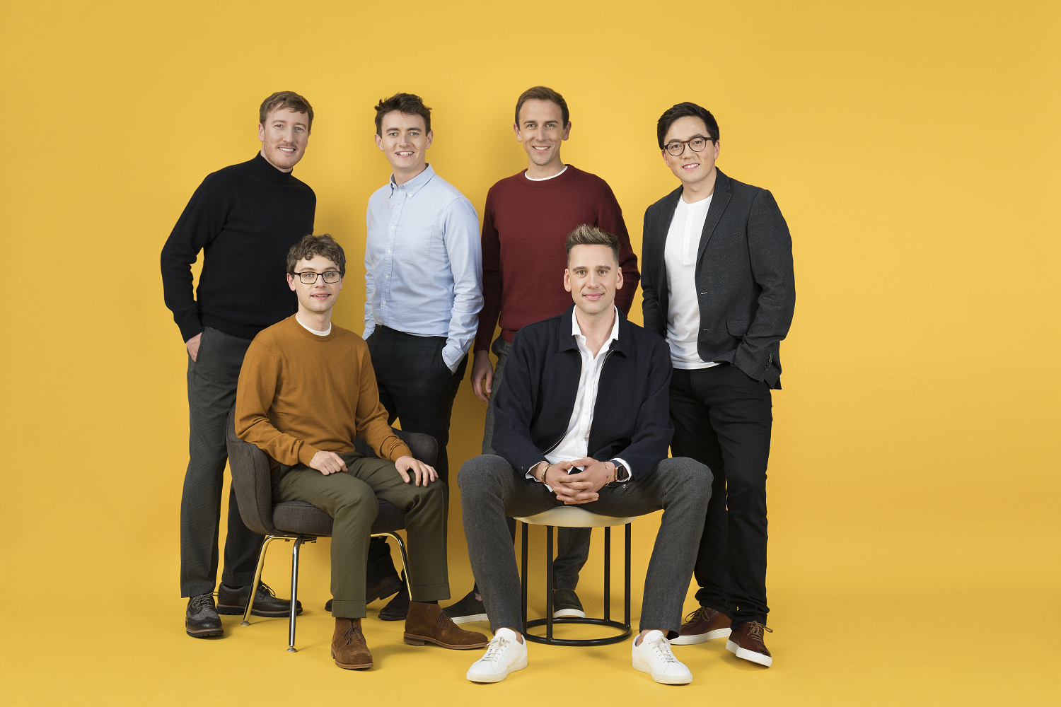Img: Six men smiling in photoshoot