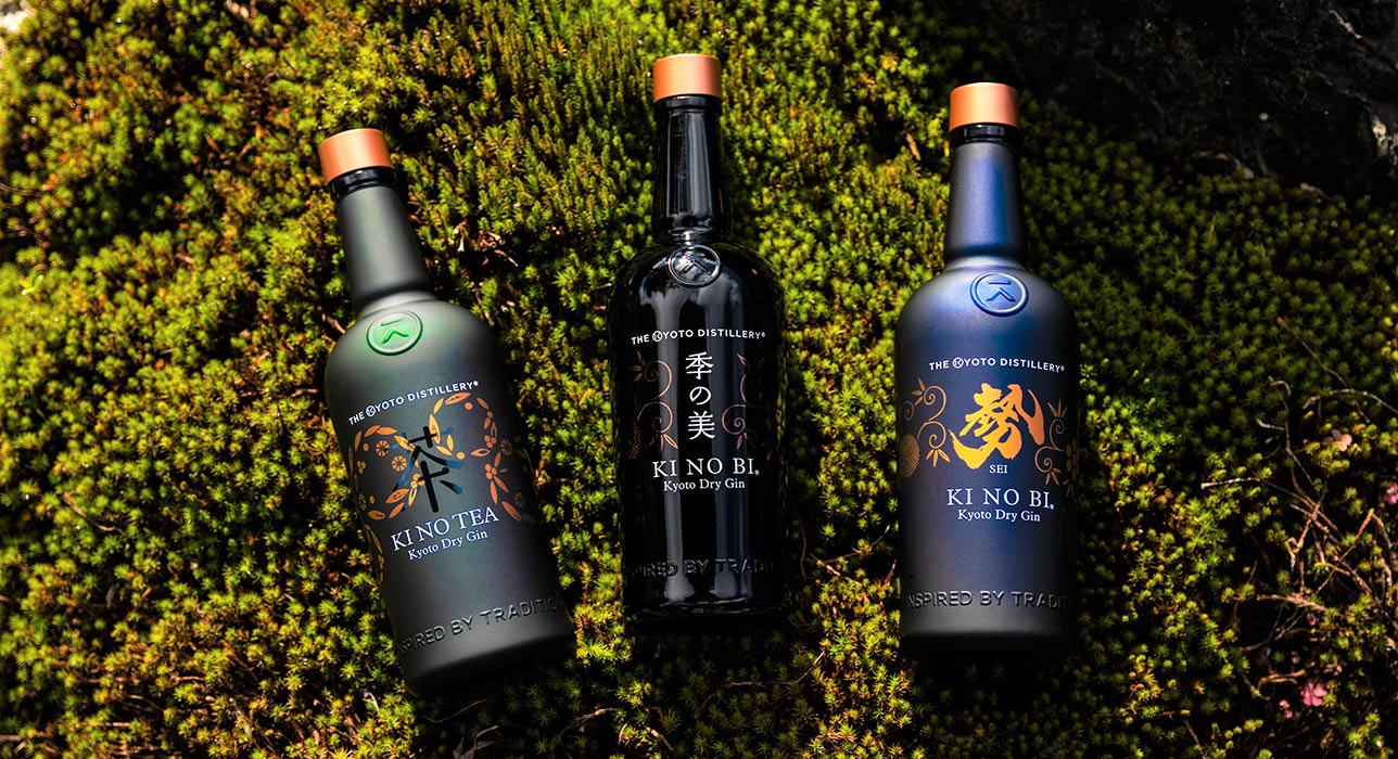 Img:Ornate bottles on gin lying on grass