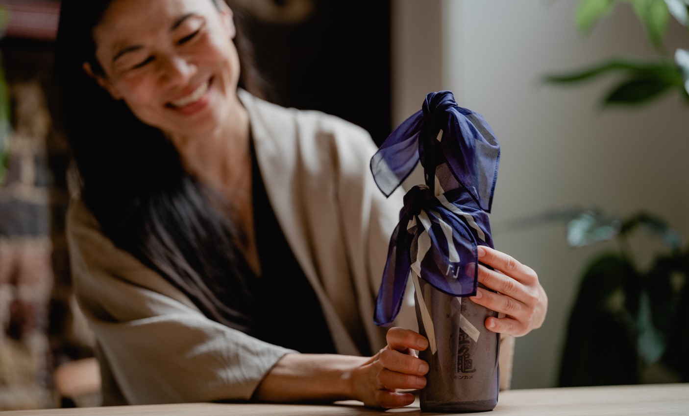 Woman wrapping a bottle in cloth