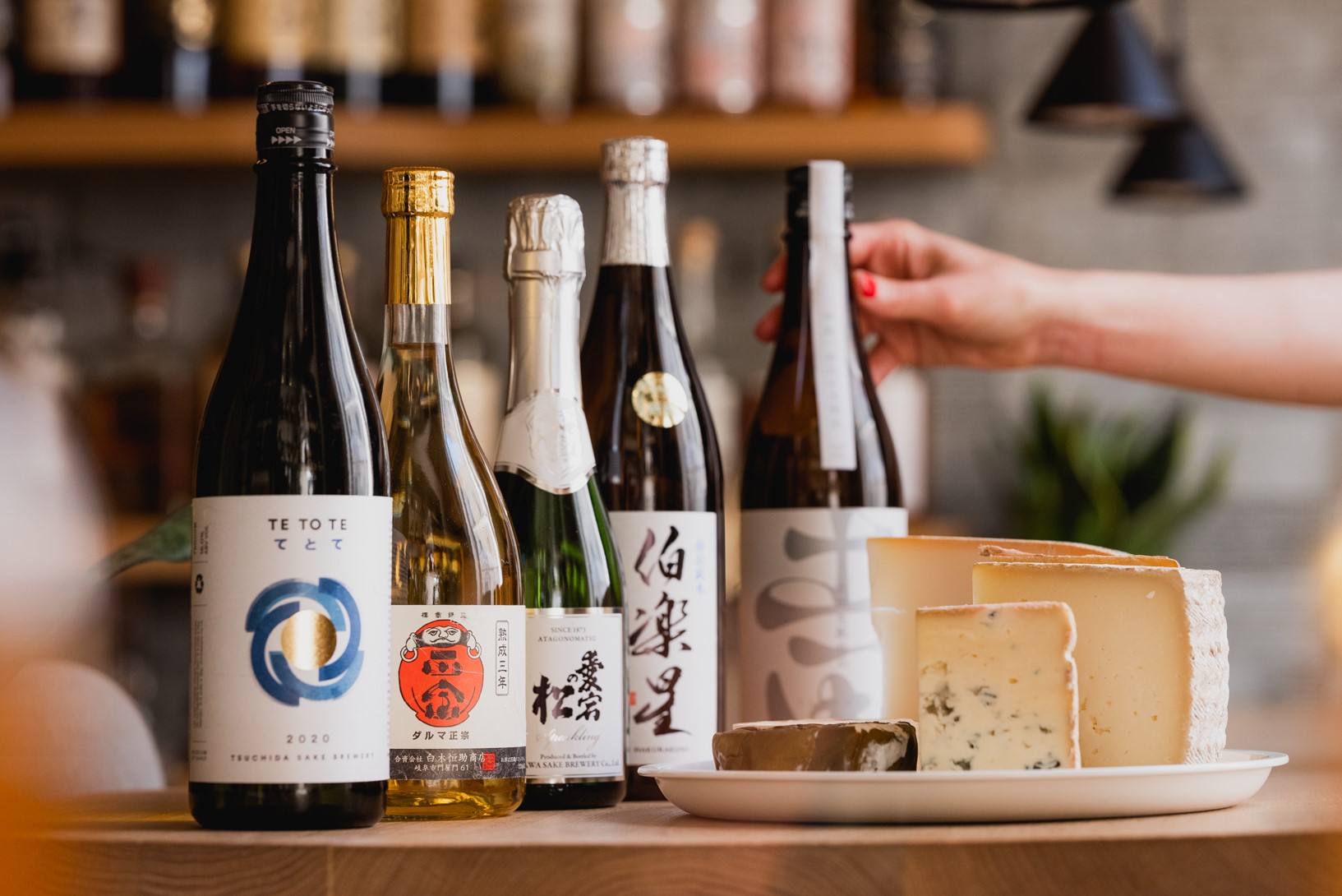 Sake bottles and cheese wheels