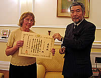 Ambassador Nogami presents Miss Brooks with her certificate