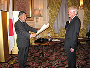 Ambassador Nogami reads the certificate to Professor Stockwin