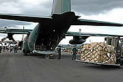 Emergency supplies are unloaded from an SDF aircraft at Banda Aceh Airport, Sumatra