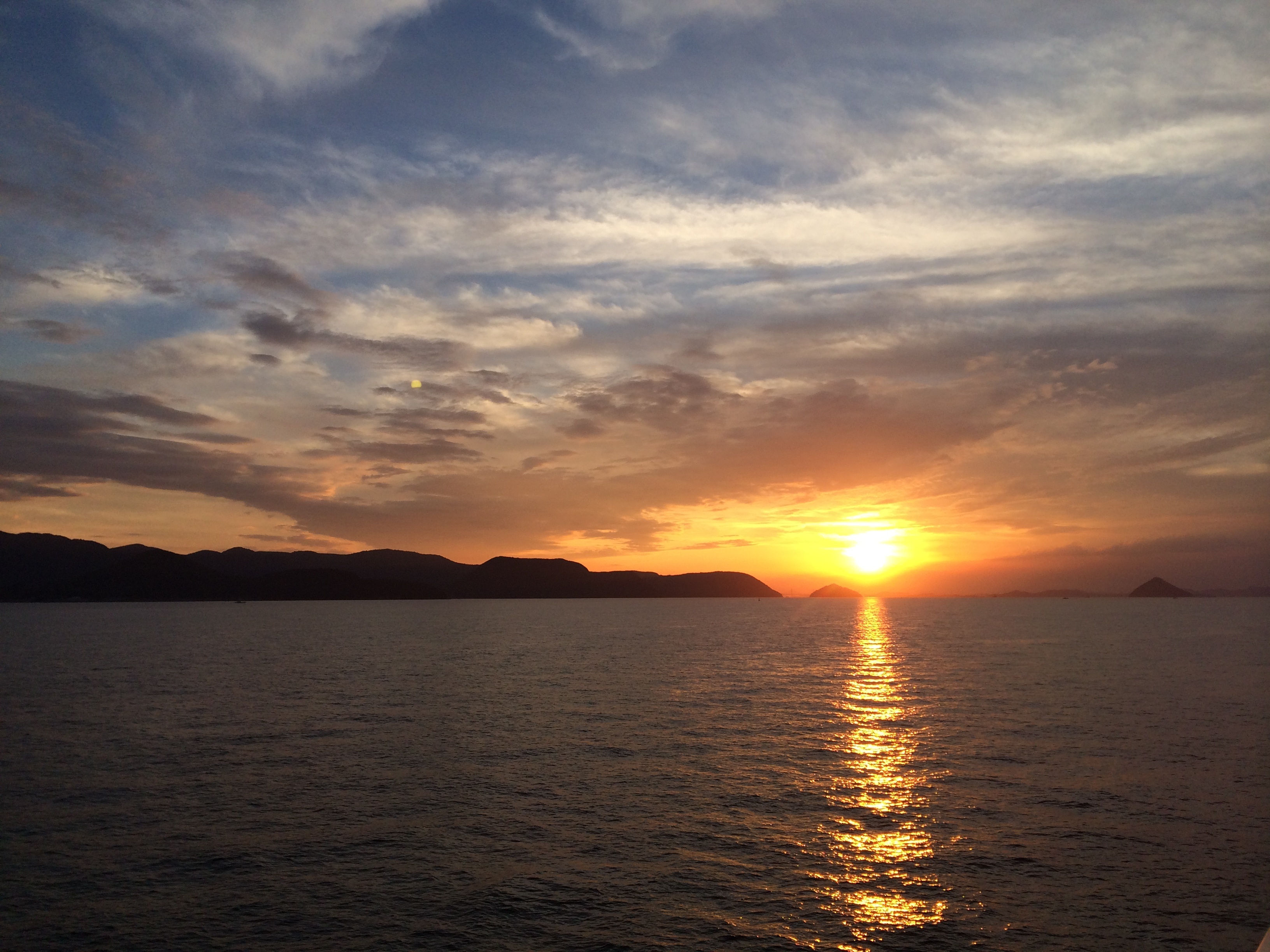 The summer sun sets over the Seto Inland Sea, taken from the ferry